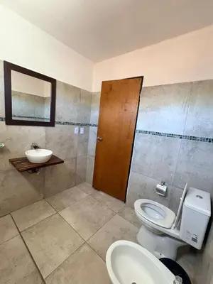 a bathroom with a toilet and a sink at SIMION in Villa Carlos Paz