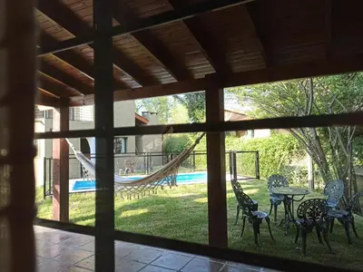 a view of a patio with a hammock and a playground at Papa Ruku in Villa Ciudad Parque