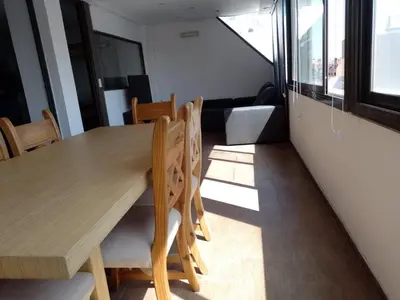 a dining room with a wooden table and chairs at Piso Completo en Nueva Córdoba in Cordoba