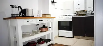 a kitchen with a stove and a counter with pots and pans at Piso Completo en Nueva Córdoba in Cordoba