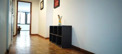 a hallway with a black cabinet and a white wall at Piso Completo en Nueva Córdoba in Cordoba