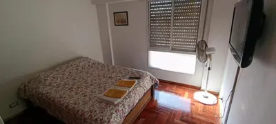 a small bedroom with a bed and a window at Illía Residential Apartament in Cordoba