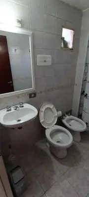 a bathroom with a toilet and a sink at Illía Residential Apartament in Cordoba