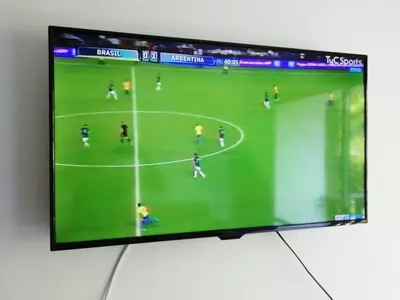 a television screen with a soccer game on it at Illía Residential Apartament in Cordoba