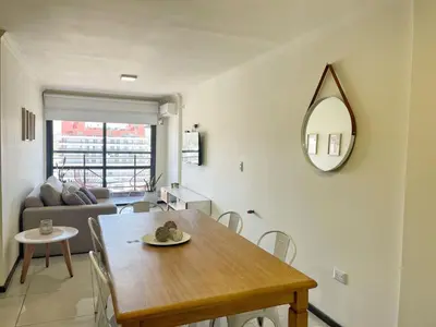 a living room with a table and a mirror at Miralejos 7 - 100 mtrs peatonal in Villa Carlos Paz