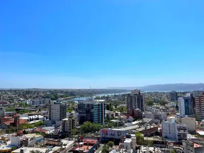 a view of a city with a river and buildings at Miralejos 7 - 100 mtrs peatonal in Villa Carlos Paz