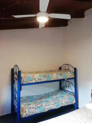 a blue shelf in a room with a ceiling fan at Carlos Paz Colinas House in Villa Carlos Paz