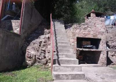 a set of stairs leading to a stone building at Carlos Paz Colinas House in Villa Carlos Paz