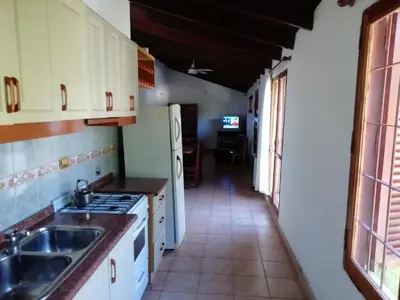 a kitchen with a sink and a stove at Carlos Paz Colinas House in Villa Carlos Paz