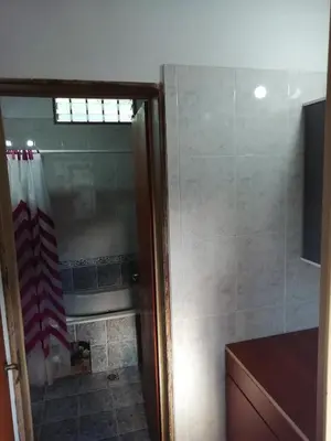 a bathroom with a shower and a bath tub at Carlos Paz Colinas House in Villa Carlos Paz