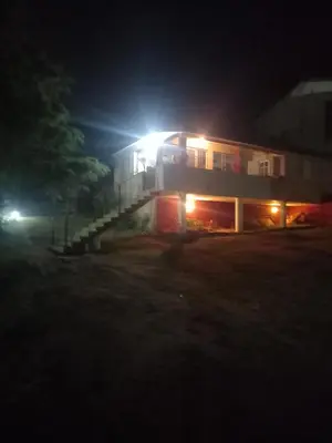 a building with lights on the side of it at night at MIRADOR DEL LAGO - La Vista in Villa Parque Siquiman