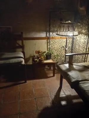 a room with a bed and a table with a lamp at MIRADOR DEL LAGO - La Vista in Villa Parque Siquiman