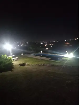 a night view of a park with a bench and lights at MIRADOR DEL LAGO - La Vista in Villa Parque Siquiman