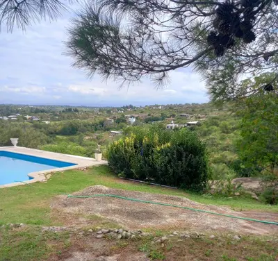 a yard with a swimming pool and a tree at MIRADOR DEL LAGO - La Vista in Villa Parque Siquiman