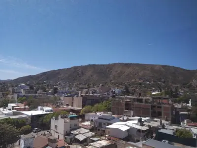 a view of a city with a mountain in the background at Torre del Lago V in Villa Carlos Paz