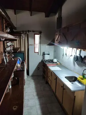 a kitchen with a sink and a counter top at Casa del arroyo in Villa General Belgrano