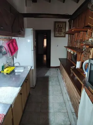a kitchen with a sink and a counter top at Casa del arroyo in Villa General Belgrano