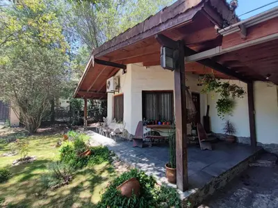 a porch of a house with a wooden roof at Casa del arroyo in Villa General Belgrano