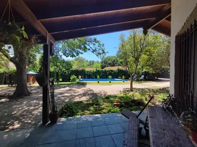 an open porch with a view of a yard at Casa del arroyo in Villa General Belgrano