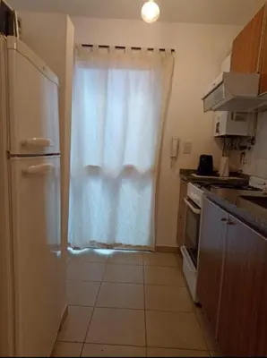 a kitchen with a refrigerator and a white curtain at Apartamentos Santa Rosa 1B in Cordoba