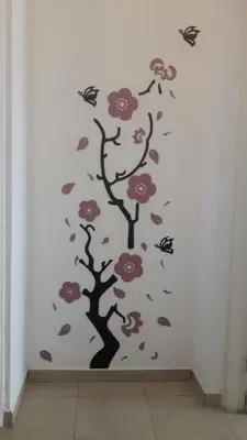 a wall mural of a tree with flowers and butterflies at Apartamentos Santa Rosa 1B in Cordoba