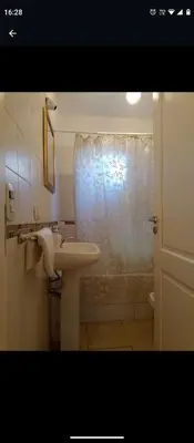a bathroom with a sink and a shower curtain at Apartamentos Santa Rosa 1B in Cordoba