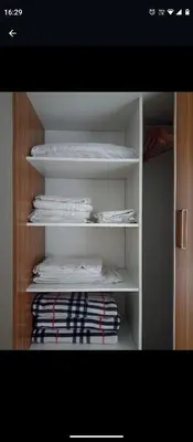 a closet with white shelves with towels on it at Apartamentos Santa Rosa 1B in Cordoba