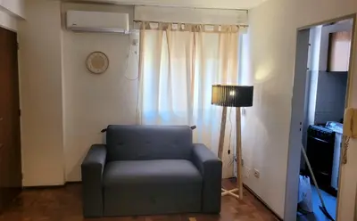 a living room with a chair and a lamp at cañada in Cordoba