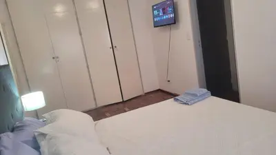 a bedroom with a bed and a tv on the wall at cañada in Cordoba