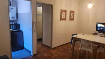 a room with a table and a television and a door at cañada in Cordoba