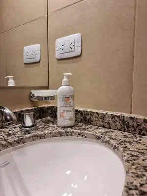 a bathroom sink with a bottle of soap on a counter at Nueva Córdoba - Premium in Cordoba