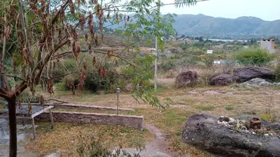 a bench sitting on top of a hill at Cabañas La Rustica 6p in Bialet Massé