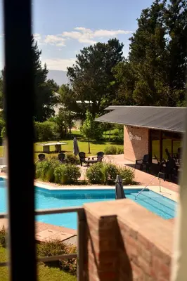 a view of a swimming pool from a window at La Rosa Apart Hotel - Solo Parejas in Mina Clavero