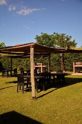 a group of tables and chairs under a gazebo at La Rosa Apart Hotel - Solo Parejas in Mina Clavero