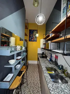 a kitchen with a sink and a counter at DEPARTAMENTO VIP PREMIUM EN EL CENTRO - Arte y Vistas panorámicas a toda la ciudad y el río in Cordoba