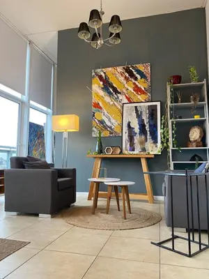 a living room with a couch and a table at DEPARTAMENTO VIP PREMIUM EN EL CENTRO - Arte y Vistas panorámicas a toda la ciudad y el río in Cordoba