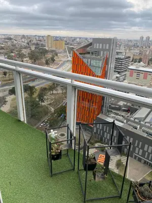 a balcony of a building with a view of a city at DEPARTAMENTO VIP PREMIUM EN EL CENTRO - Arte y Vistas panorámicas a toda la ciudad y el río in Cordoba