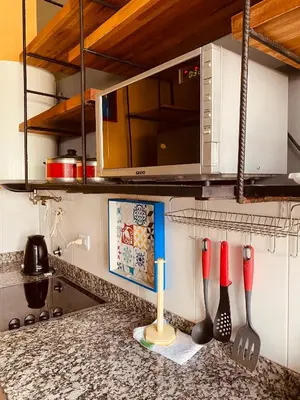 a kitchen counter with utensils on a counter top at DEPARTAMENTO VIP PREMIUM EN EL CENTRO - Arte y Vistas panorámicas a toda la ciudad y el río in Cordoba