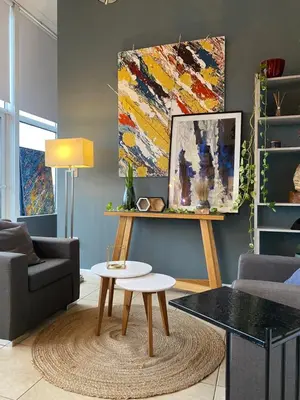 a living room with a couch and a table at DEPARTAMENTO VIP PREMIUM EN EL CENTRO - Arte y Vistas panorámicas a toda la ciudad y el río in Cordoba