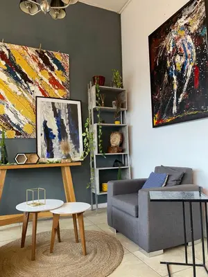 a living room with a couch and a table at DEPARTAMENTO VIP PREMIUM EN EL CENTRO - Arte y Vistas panorámicas a toda la ciudad y el río in Cordoba