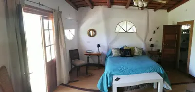 a bedroom with a bed with a blue blanket at La Ecle in San Javier