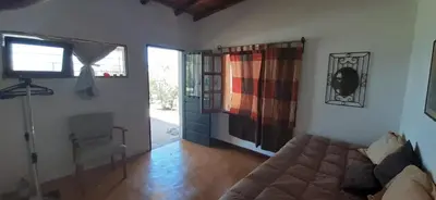 a living room with a bed and a window at La Ecle in San Javier