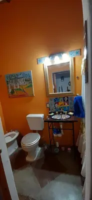 a bathroom with a toilet and a sink and a mirror at La Ecle in San Javier