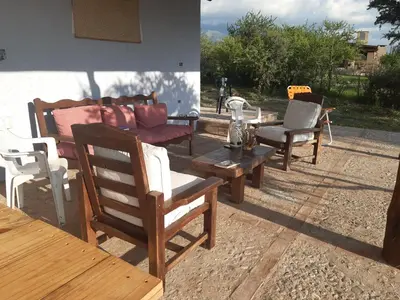 a group of chairs and a wooden table and bench at La Ecle in San Javier