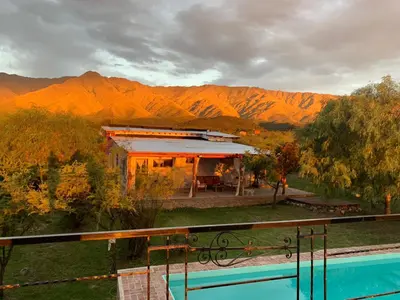 a house with a swimming pool in front of a mountain at La Ecle in San Javier