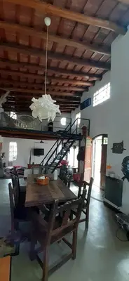 a dining room with a wooden table and a chandelier at La Ecle in San Javier