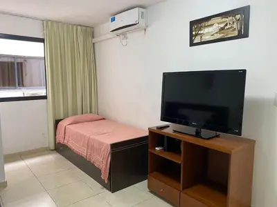 a small room with a television and a bed at Departamento Sorrentos in Villa Carlos Paz