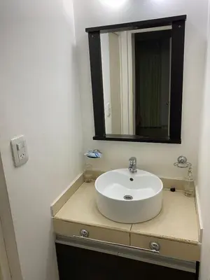 a bathroom with a white sink and a mirror at Departamento Sorrentos in Villa Carlos Paz