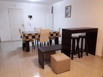 a dining room with a table and chairs at Departamento Sorrentos in Villa Carlos Paz