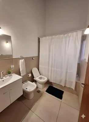 a bathroom with a toilet and a sink and a shower at CABAÑA MAR - FINCA PUDUAM in Villa General Belgrano